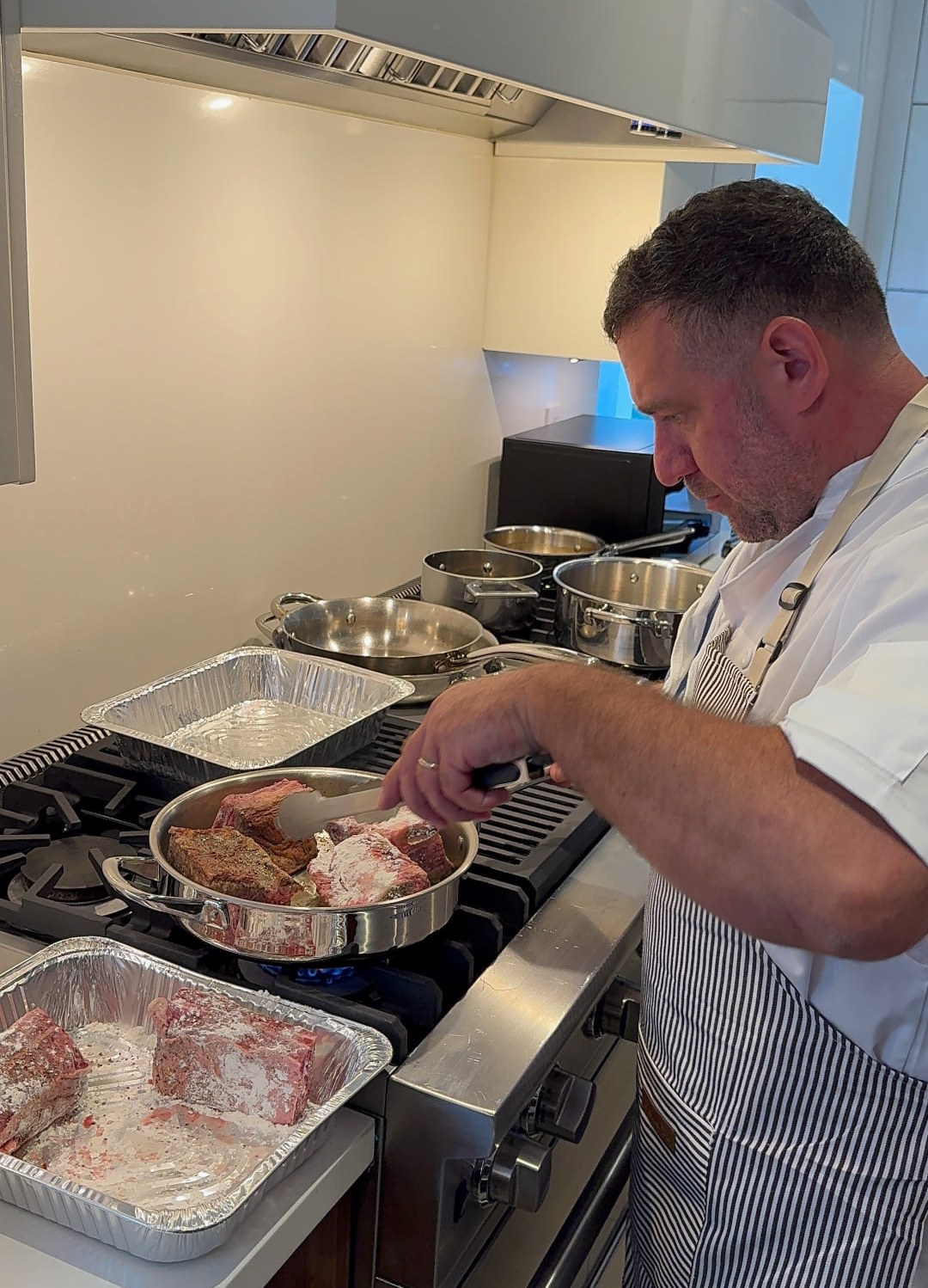 Chef Leo Rudnitsky searing kosher short ribs on a client's range in Florida