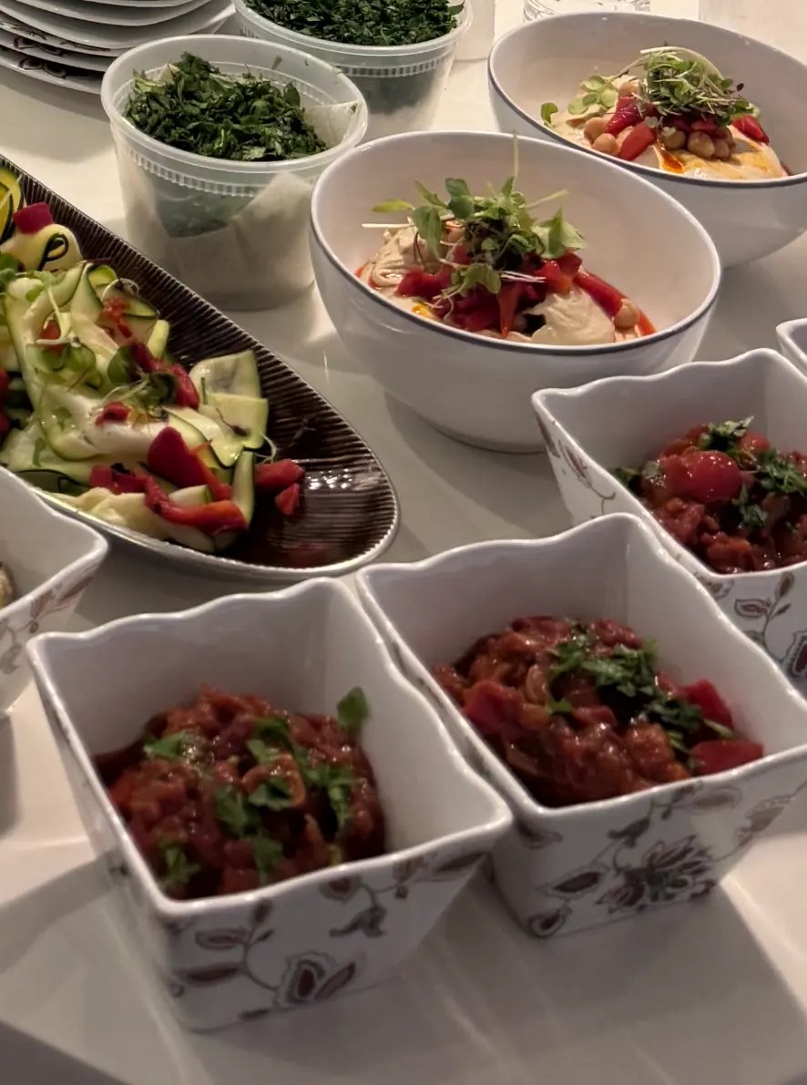 Kosher mezze spread with hummus, matbucha and marinated zucchini prepared for a Florida event