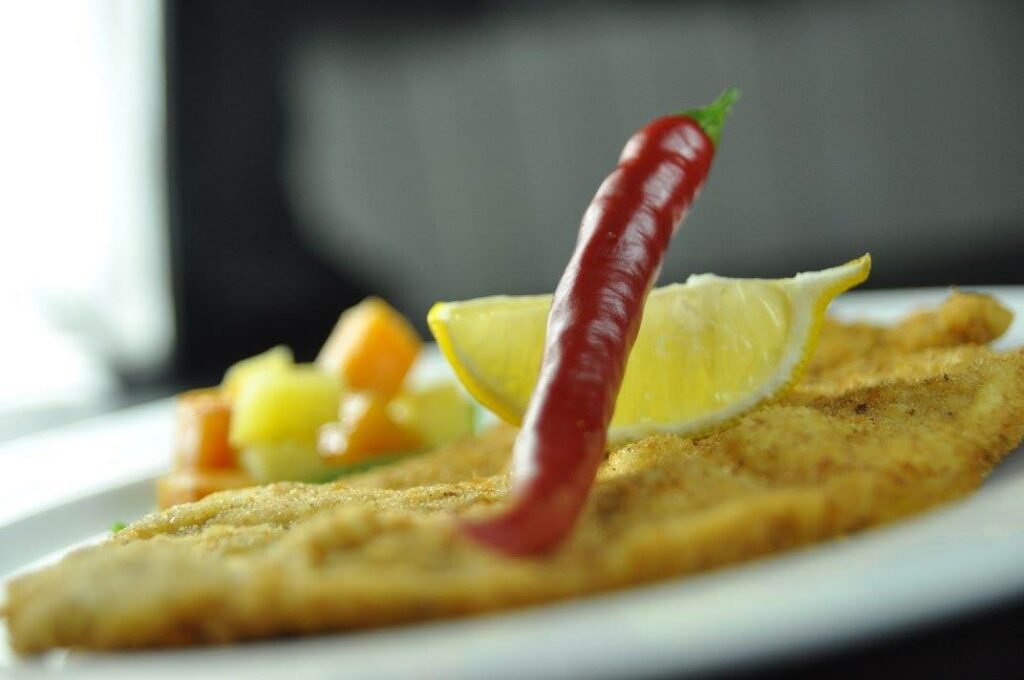 Kosher Chef in St. Augustine preparing a gourmet kosher meal for a private dining experience, using fresh ingredients.